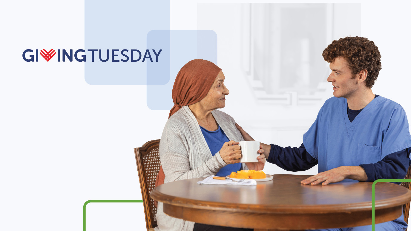 Caretaker and patient sit at a table looking at each other